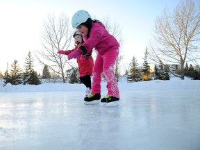Kiana Kloberdanz, 5, left, and Brooklynn Lorencz, 5, work their way down a clean sheet of ice at the Muskoseepi Park pond on Saturday. Temperatures hovering around the freezing mark made the perfect day for outdoor skating. (Adam Jackson/Daily Herald-Tribune)