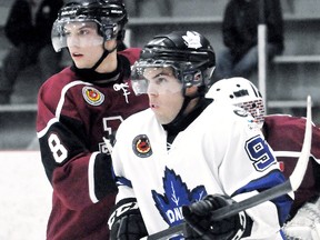 Chatham Maroons' Ben Pataki, left, fights for position with London Nationals' Aaron Dartch in the third period Sunday at Memorial Arena. (MARK MALONE/The Daily News)