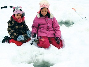 Maia (left) and Nina Vanasse try their hand at ice fishing for the first time at the fishing derby on Sunday afternoon, Feb. 10.

ALAN S. HALE/Daily Miner and News