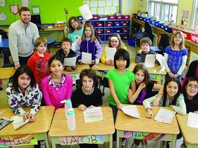 Leslie Myles, managing director of the Limestone Learning Foundation, shared letters written by students she met in Nepal during her recent trip to Mt. Everest, with Kevin Wood, Grade 4-5 teacher, and his class at Central Public School.        Rob Mooy - Kingston This Week