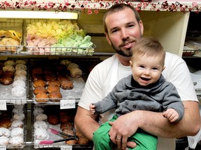 Geoffrey van Heeswijk carries on the paczki baking tradition like his father Baker Ben, and perhaps in the future so will his son eight-month-old Paxton. van Heeswijk will produce about 2000 of the decadent donuts in a 24 hour span at Pinnell Bakery in Ridgetown, On., PHOTO TAKEN Monday February 11, 2013 DIANA MARTIN/ THE CHATHAM DAILY NEWS/ QMI AGENCY