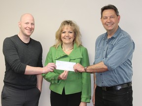 Geoffrey Person and Mary Lee Prior receive a cheque to help make the Vermilion Winter Fair bigger and better.