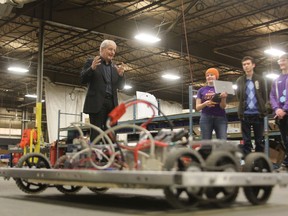 Federal Liberal leadership candidate Marc Garneau talks to high school robotics pupils during a visit to Transformix in Kingston Monday afternoon. (Elliot Ferguson The Whig-Standard)