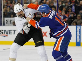 Darcy Hordichuk, seen here tangling with Anaheim Ducks enforcer George Parros last spring, has been put on waivers by the Oilers. (Perry Nelson, Edmonton Sun)