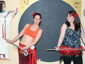 Karen Savoie, owner and instructor of the Belly Dance Academy, left, and Today reporter Amanda Richardson practice the finer points of belly dancing at Savoie’s home studio. JORDAN THOMPSON/TODAY STAFF