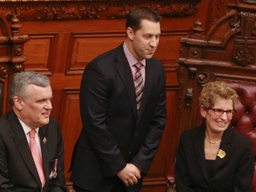 New Minister of Natural Resources David Orazietti (centre) stands beside Lt. Governor David Onley and Premier designate Kathleen Wynne during the swearing in ceremony Monday at Queen’s Park.