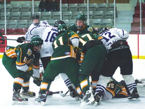 Broncos’ Logan Ginn and Chris Hrabec try to find the loose puck while the Warriors’ goalie lunges out to make the save. Beaver Brae lost 3-1.
GRACE PROTOPAPAS/Daily Miner and News