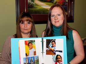 Joyce Marentette, left, and Sarah Longmore hold some pictures of five-year-old Nevaeh Hickmott, who is suffering from Still's disease, along with Macrophage activation syndrome, a severe and potentially life-threatening complication. They are planning to organize some fundraisers to help the family. Photo taken Monday, Feb. 11, 2013, in Chatham, Ont. (ELLWOOD SHREVE/ THE CHATHAM DAILY NEWS/ QMI AGENCY)