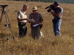Let's Go Outdoors host Michael Short (centre) reviews a map with a conservation officer in one episode from this season