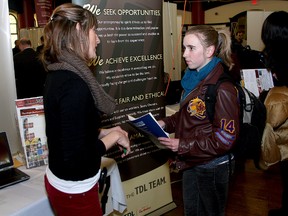 Natasha Moon of Tim Hortons Distribution Centre speaks with Queen's University student Bethany Gray at the Live & Work Kingston career fair at Grant Hall on Tuesday. Forty employers met with students of Queen's University and St. Lawrence College for a Kingston only career fair. (Ian MacAlpine The Whig-Standard)