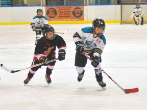 EDDIE CHAU Times-Reformer
Simcoe Novice Rep Warriors forward Ryan Oakes, right, is seconds away from scoring on the net of the Hagersville Devils during a Southern Counties Minor Hockey Association playoff game Tuesday.