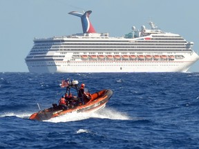 A small boat from the U.S. Coast Guard Cutter Vigorous patrols near the cruise ship Carnival Triumph in the Gulf of Mexico, in this February 11, 2013 handout photo.  REUTERS/U.S. Coast Guard/Lt. Cmdr. Paul McConnell/Handout