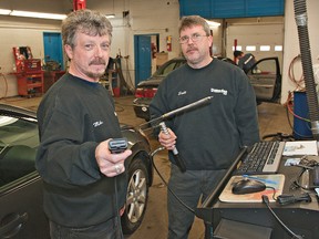 BRIAN THOMPSON, The Expositor

Drive Clean certified repair technician Mike Hassett (left) holds the new e-test cable that connects beneath the dashboard of a vehicle, while Dunsdon Auto owner Scott Birdsell holds a tailpipe emission sensor used on pre-1998 model vehicles.