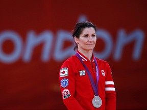 Canada's Tonya Lynn Verbeek poses with her silver medal at the podium of the Women's 55Kg Freestyle wrestling at the ExCel venue during the London 2012 Olympic Games August 9, 2012. (REUTERS)