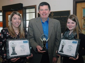 Elgin Warden Cameron McWilliam, centre, with the Economic Development department's newly received Economic Developers Council of Ontario award for the 2012 Savour Elgin/Elgin Arts Trail Guide. Joining McWilliam are business development co-ordinator Kate Burns, left, and marketing and communications co-ordinator Katherine Thompson with honourable mention plaques for the Elgin County Living television series  and the ElginLicious marketing campaign. (Nick Lypaczewski, Times-Journal)
