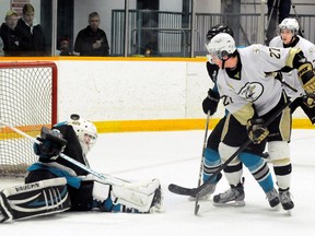 Trenton Golden Hawks' Greg Trichilo bounces a shot off Lindsay Muskies' Tanner Davis during third period action Sunday at the Community Gardens. Just moments later Trichilo would slide in the game winner as the Hawks beat the Muskies 6-4.