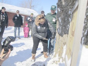 Huron-Bruce MPP Lisa Thompson was the first to tap into mother nature during a special event honouring the first tapping for maple syrup Saturday morning. Darryl Klein, right, gave a helping hand.