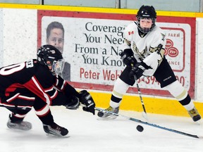 Quinte West Minor Peewee Hawks' Joshua Snider battles with Port Perry Predators' Harvey Porter during the Hawks' 2-1 win Saturday the Community Gardens.