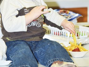 Two-year-old Samuel Blabey was content with eating French fries at the Peace Hills Adventist School's Valentine's Stop �n� Shop Evening held Feb. 10 at the facility, north of Wetaskiwin. Numerous vendors took part in the event, which doubled as a fundraiser for the school. JEROLD LEBLANC PHOTO/WETASKIWIN TIMES/QMI AGENCY