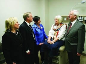 Linda Henson (seated), a patient experience advisor for Hotel Dieu Hospital, shares her experiences as a patient with (l-r) Sherri McCullough, HDH board chair, Dr. David Pichora, HDH CEO, Donna Segal, board chair for South Eastern Local Health Integration Network and John Gerretsen, MPP for Kingston and the Islands. Henson was touring one of 40 patient examination rooms located within the 36,000 square foot newly developed clinic space at Hotel Dieu Hospital.       Rob Mooy - Kingston This Week