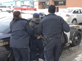 The OPP put a suspect in the back of the cruiser after executing a search warrant at residence on Government Road East.