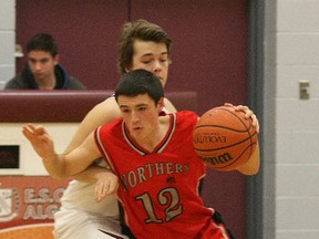 Northern Braves basketball player Eric Lachance (12) moves the ball up court against the Algonquin Barons during regular season action. (NUGGET FILE PHOTO)