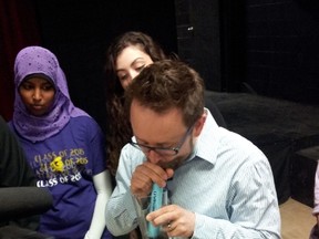 Queen Elizabeth students demonstrate the LifeStraw at their school on Feb. 7.