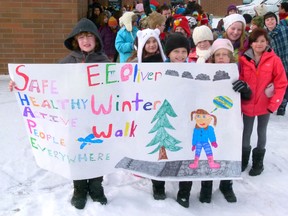 E.E. Oliver students Jayce Obrigewitch, Jordan Pohr & Sean Craig hold the Winter Walk banner