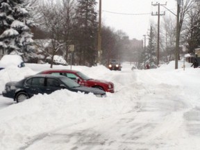 Two cars were parked sticking out onto Baird Street in Paris on Friday, Feb. 8, 2013 during a snowstorm in an apparent effort to stop a plow from snowing them in. A county official says the owners only succeeded in delaying snow removal for their neighbours. SUBMITTED PHOTO