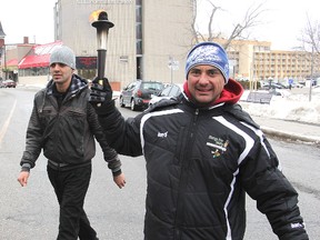 Michael Lea The Whig-Standard
Khaled Khatib, left, who had to temporarily drop out of a torch run from Ottawa to Toronto to promote the need for more organ donations, walks alongside replacement walker Frank Apuzzo as the two approach City Hall Wednesday afternoon.