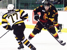 Belleville Bulls defenceman Brady Austin goes 1-on-1 with fellow blueliner, Warren Steele, of the Kingston Frontenacs, during OHL action Wednesday night at Yardmen Arena. (Luke Hendry/The Intelligencer.)