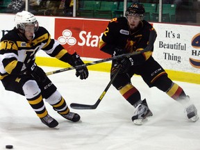 Kingston Frontenacs defenceman Warren Steele and Belleville Bulls defenceman Brady Austin battle for the puck during first-period Ontario Hockey League play Wednesday night at Yardmen Arena in Belleville. The Bulls won 4-1. (Luke Hendry/QMI Agency)