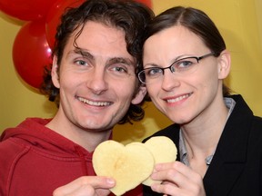 Aleksandar Nikolic and Maja Juric with two of the heart-shaped coconut cookies they will be handing out in front of city hall this evening.