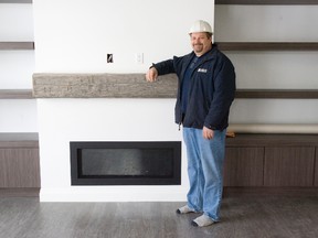 London Home Builder's Association vice-president Ted Melchers stands at the gas fireplace featuring a reclaimed wood mantel in the LHBA's Green Home at 1511 North Wenige Dr. (DEREK RUTTAN, The London Free Press)