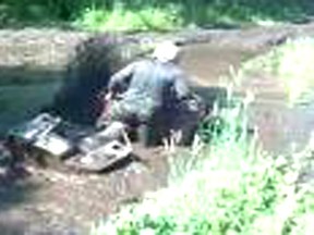 An off-highway vehicle (OHV) rider is shown stuck in a bog marsh in the Hell’s Half Acre area in Parkland County. A local OHV association is proposing to designate the area as an official OHV Park. Some area residents have expressed concerns regarding potential environmental damage and high traffic /increased noise levels.