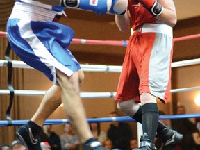 Trinity fighter Chris Anderson (red) stalks opponent Wade Goszulak of Medicine Hat en route to a unanimous decision victory. 
PHOTOS BY JAEGER GUSTAFSON