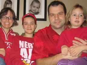 The Kozak family wearing the red shirts they had to borrow from friends as part of the A Walk in Other’s Shoes: Poverty Challenge. Left to right: Avery, 5; Melanie; Charis, 13; Dean; Payton, 3.