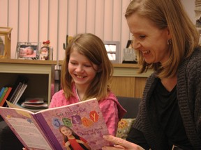 Desiree Sweetapple, 10, left, and her mom Tracey take a look at a book about living with ADHD. Desiree became more interested in learning about her condition after attending the GLOW for LD/ADHD program.
TESSA CLAYTON/AIRDRIE ECHO
