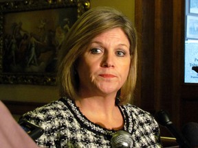 NDP Leader Andrea Horwath emerges from a meeting with Premier Kathleen Wynne at Queen's Park on Thursday, February 14, 2013, to tell reporters she expects her priorities to be addressed in the throne speech including a rate reduction in car insurance premiums. (Toronto Sun/Antonella Artuso)