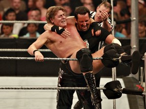 KEN ARMSTRONG QMI File Photo
Tommy Dreamer, in black, places William Regal on the top turnbuckle during a WWE live event in Edmonton in 2009.