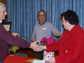 Mayor Pat Sobeski shakes his opponent Susan Woods hand following their spelling bee match. Quizmaster Brad Janssen stands in the background.  (TARA BOWIE, Sentinel-Review)