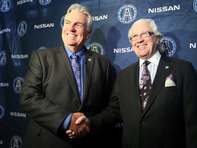 The Double Blue’s big boss Chris Rudge (right) congratulates his general manager Jim Barker for a job well done and a new contract which runs until the end of the 2015 CFL season. (DAVE ABEL/TORONTO SUN)