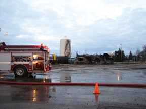 A fire that demolished this canola oil pressing plant in a Quonset in the industrial area in northwest Mayerthorpe smoulders as firefighters take a break at about 8 a.m. on Saturday, Oct. 13, after knocking it down. Following an investigation a Fire Commissioners Office spokesperson said the cause was undetermined. After the fire, Mayerthorpe Fire Chief Randy Schroeder said the town’s fire department got called out to the blaze at about 3:30 a.m.  Ten town firefighters and two from the Sangudo Fire Department who were called in to provide tanker support worked on it.  He said no one was hurt. “Nobody was in it (the Quonset) at the time.”
Ann Harvey | QMI Agency