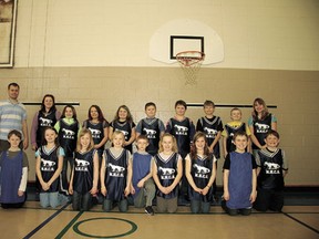 The New Humble Centre School basketball teams, the first such teams the school  has had in perhaps its entire 113-year existence, gather with coach Brad Hayes in the school’s gymnasium.