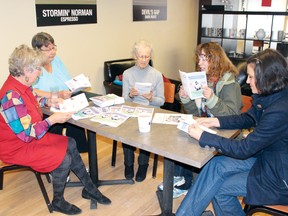 Sallie Hunt, Barb Larson, Phillis Lockhart, Sheila Sheild and Fay Clark read the new Homeless in Kenora booklet at its launch event on Thursday afternoon.
ALAN S. HALE/Daily Miner and News