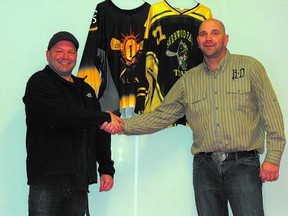 Edmonton Eclipse president Warren Sheen (left) shakes hands with Titans Junior teams president Stacey Dziwenko to cement a deal that sees the Junior A Eclipse relocate to Sherwood Park. Photo supplied.