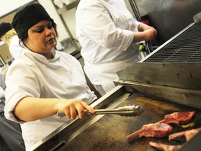 Jessie Braun, 23, cooks on the line at Creations in Sarnia, Ont. Thursday Feb. 14, 2013. (TYLER KULA, The Observer)
