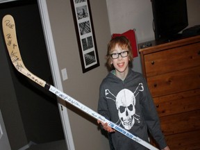 Nathaniel Crossley, 11, is trading an Edmonton Oilers hockey stick signed by all players, to raise awareness and funds for The African Well Foundation. SUPPLIED PHOTO