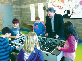 Brant MP Phil McColeman plays foosball with a group of youngsters at the Boys and Girls Club facility on Edge Street. McColeman announced $228,000 in funding is going towards the club from the Community Infrastructure Improvement Fund. (SUSAN GAMBLE The Expositor)