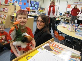 Will Arnburg, an Elmer Elson Elementary School kindergarten student in the class of teacher, Rhonda Bablitz, accepts a flower arrangement brought to him in class by Julinne Laughran of Petal Plus on Valentine’s Day, Feb. 14. The flowers were a gift from his family. Laughran said she had 10 more deliveries to make at the school.